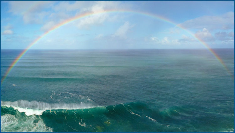 A perfect rainbow over ocean waves